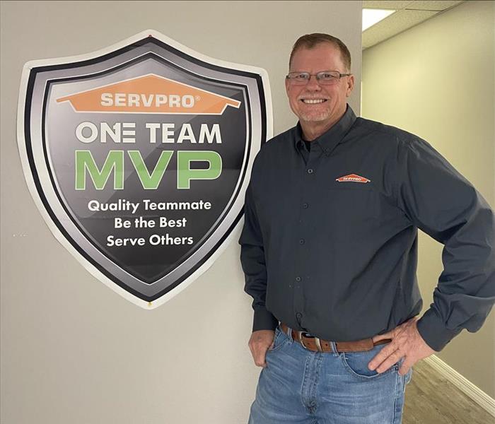 Greg Williams standing in front of a SERVPRO sign